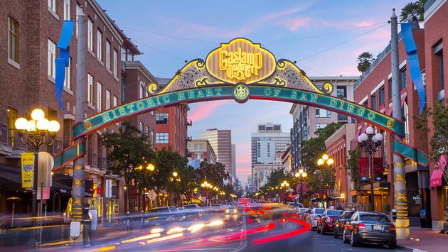 Sunlit San Diego street lined with local restaurants and attractions.